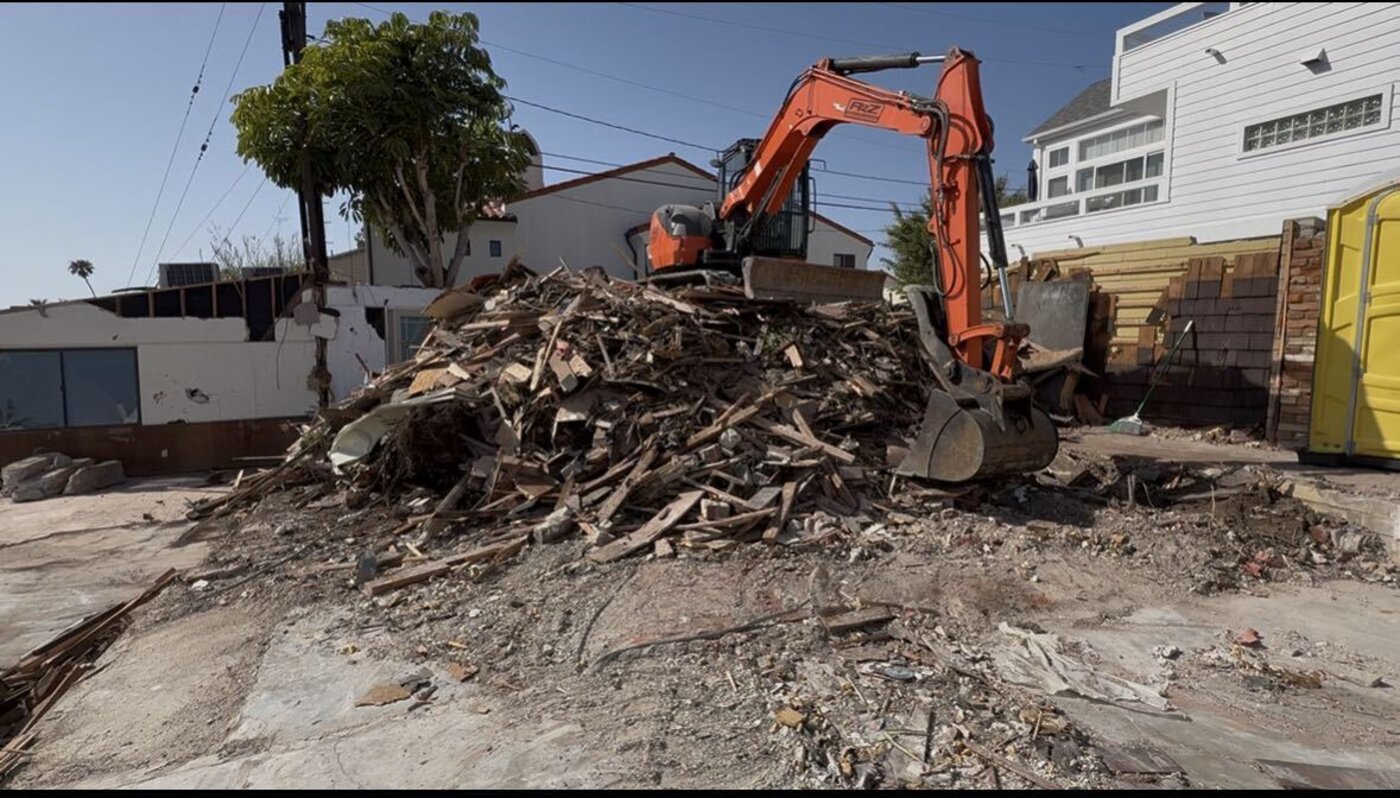 A2Z excavator clearing demolition debris on a job site