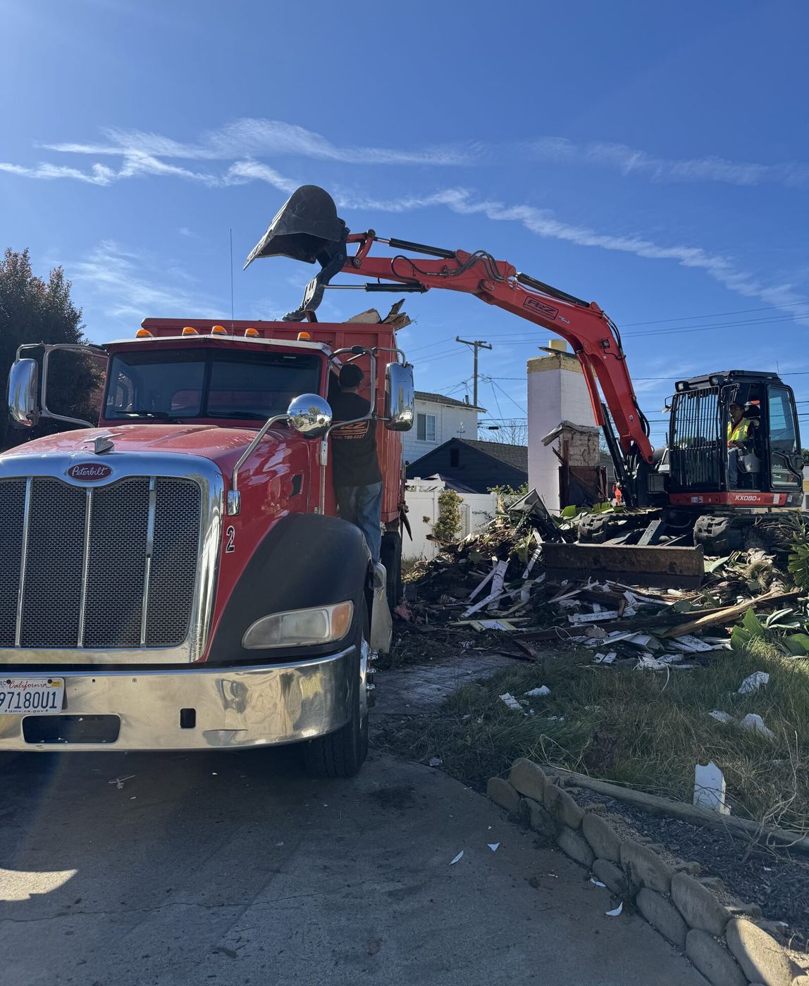 A2Z excavator loading soil and debris into a dump truck