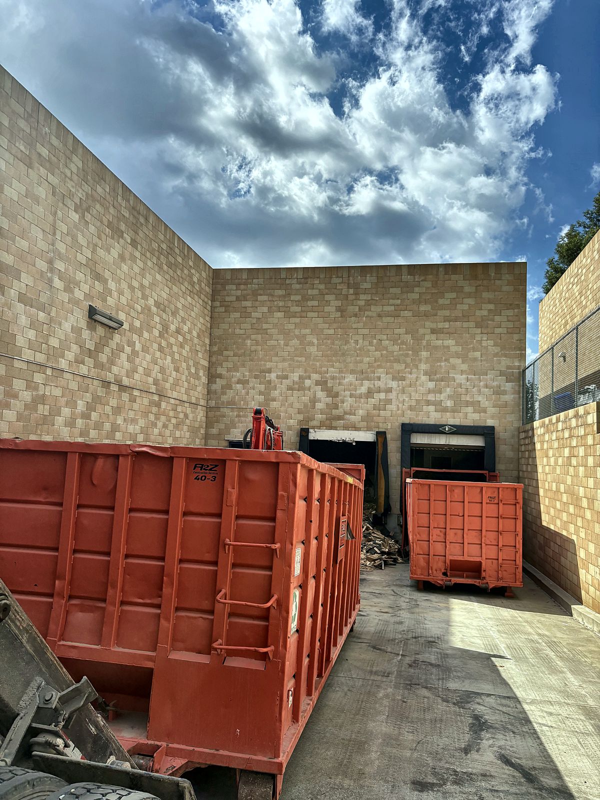 Two A2Z 40 yard roll off containers at a commercial loading dock during a cleanout