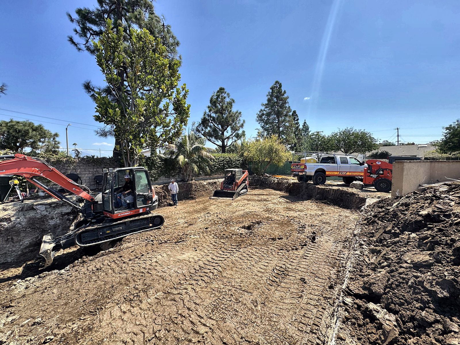 A2Z excavator and skid steer excavating and grading a residential lot