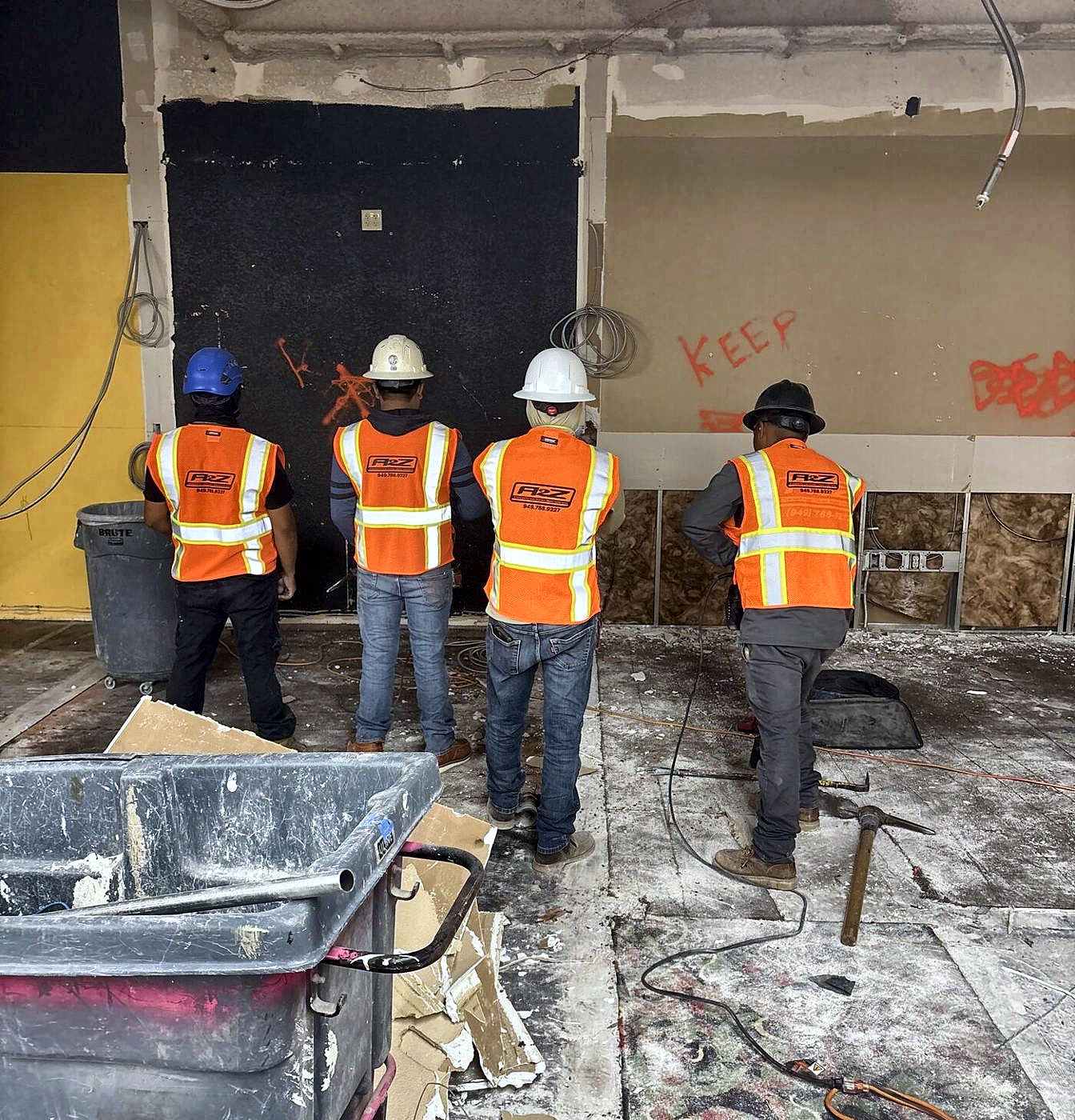 A2Z labor crew in safety vests on a tenant improvement demolition